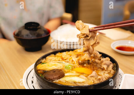 Two people are eating pork shabu or hot pot. Family time. Stock Photo