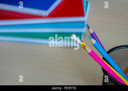 wooden pencils and Notebooks  on a desk  wooden background. Stock Photo