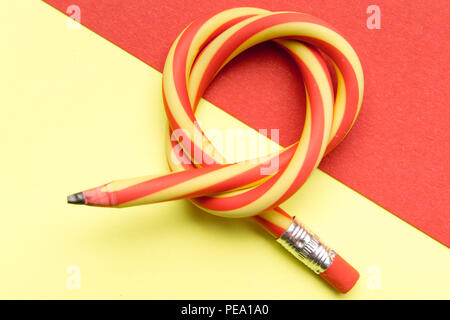 Flexible pencil on a textured cardboard background. Bent pencils two-color  Stock Photo - Alamy