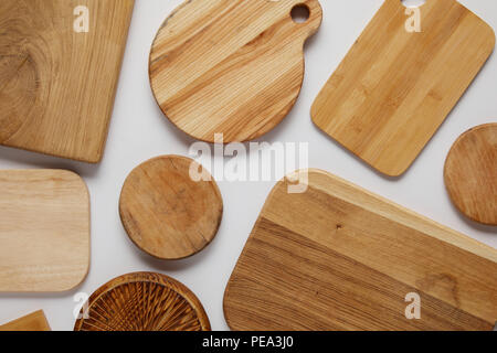 top view of various wooden cutting boards on white table Stock Photo