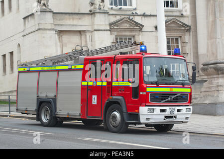 A Fire Engine from West Yorkshire Fire & Rescue passes in front of Leeds Civic Hall Stock Photo