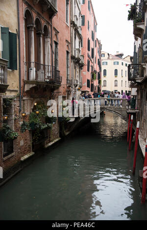 Bridge over a canal that runs below the windows of Trattoria Sempione restaurant, Venice Stock Photo