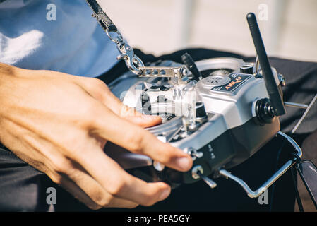 Hands holding joystick control panel on background Stock Photo