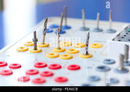 Beautiful set of tools for implant dentists located in nests in a certain order on a blue background Stock Photo