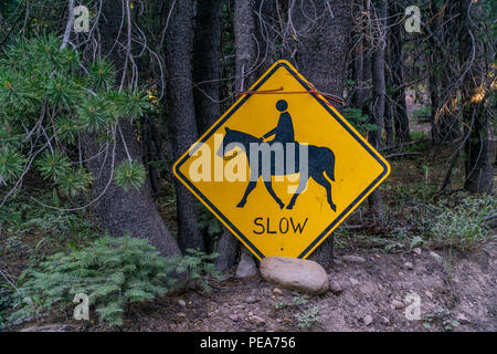 A slow sign along forest road 5N01 in the Stanislaus National Forest, California Sierra Nevada mountains Stock Photo