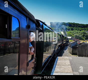 A passenger waits for departure in a steam train at Keighley station on the KWVR line Stock Photo