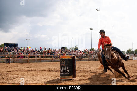 Cowgirls guide their quarterhorses through the barrell racing course during the Ram Rode Tour in Exeter, Ontario, Canada. Stock Photo
