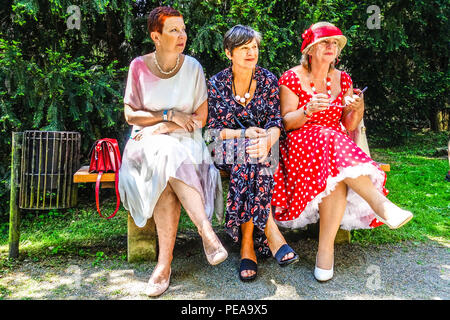 Elderly bench people, Three senior women in summer dresses, sitting on a bench in a park, Czech Republic Senior bench Ladies generation Stock Photo