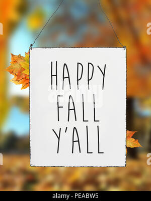 Happy fall you all autumn text on white plate board banner leaves blur background Stock Photo