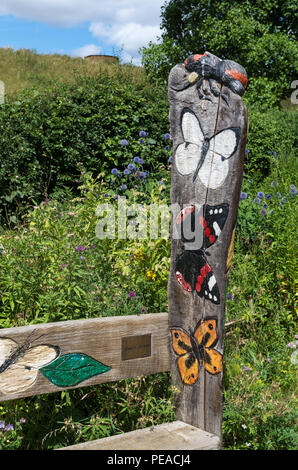 Wooden sign with painted butterfly replicas, Butterfly Garden, Sywell Country Park, Northamptonshire, UK Stock Photo