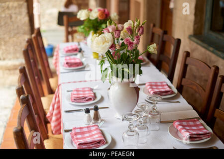 Shot of a table set for a meal at the restaurant with outdoor terrace. Stock Photo