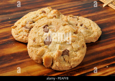 Three white and dark chocolate chip cookies with macadamia nuts Stock Photo