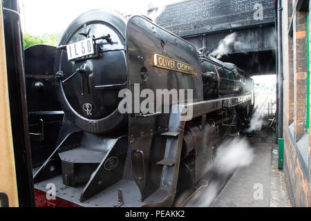 British Railways Britannia Class 76PF steam locomotive Number 70013 'Oliver Cromwell' at Loughborough Station pulling a passenger train Stock Photo