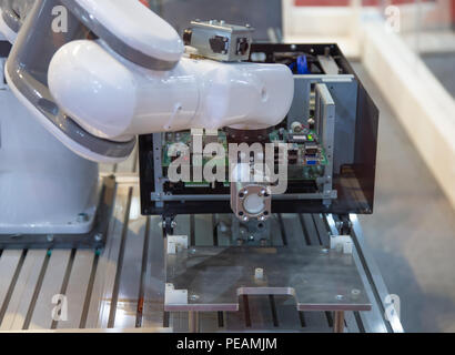 Automated industry robotic arm computer electronic assembly Stock Photo