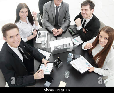 business team sitting at Desk and looking at camera. Stock Photo