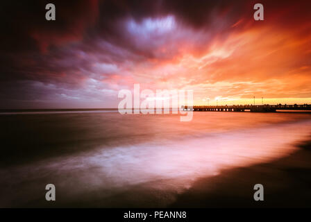 Sunset near a pier on the beach in Ostia (Rome - Italy) Stock Photo