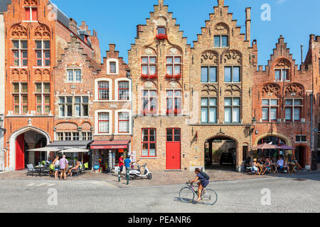 Cafes, restaurants and shops on Academiestraat near Het Tolhuis and Jan van Eyckplein, Bruges, Belgium Stock Photo