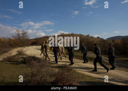 Kosovo Force and Kosovo Border Police conduct a joint patrol on the Administrative Boundary Line between Kosovo and Serbia, Nov. 17, 2015, in Rogaqic, Kosovo. KFOR, NATO’s peace support mission in the region since 1999, is beginning to integrate KBP personnel into ABL patrols as part of their mission to ensure safety, security and freedom of movement in Kosovo. (U.S. Army photo by Sgt. David I. Marquis, Multinational Battle Group-East) Stock Photo