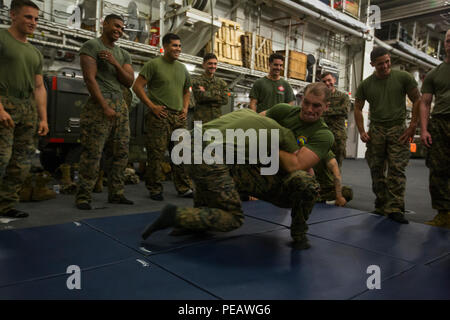 U.S. Marines from Special-Purpose Marine Air-Ground Task Force-Crisis Response-Africa participated in Marine Corps Martial Arts Program training aboard HMS Ocean of the United Kingdom Royal Navy on November 14, 2015, during exercise Blue Raptor. The training demonstrated the Allied Maritime Basing Initiative, a proof-of-concept for a year-round, maritime-based crisis response force. Exercises included amphibious operations, joint training with UK Royal Marines, and coordination with NATO and EUCOM expeditionary forces. Stock Photo