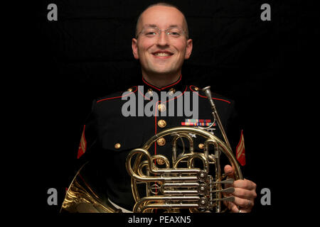 Cpl. Aaron Atwood poses for a photograph holding his French Horn Nov. 5, at Marine Recruiting Station Springfield’s Headquarters. The 27-year-old Danbury, Conn.-native used his Post 9/11 G.I. Bill to obtain a Bachelor’s of Music Performance Classical French Horn from Western Connecticut State University. Atwood has reenlisted into the Marines so that he can have a career as a full time preforming musician. He will be with the Marine Band stationed in New Orleans, La. Stock Photo