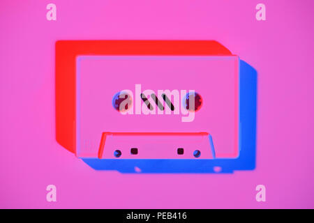 toned pink picture of retro audio cassette on pink surface Stock Photo