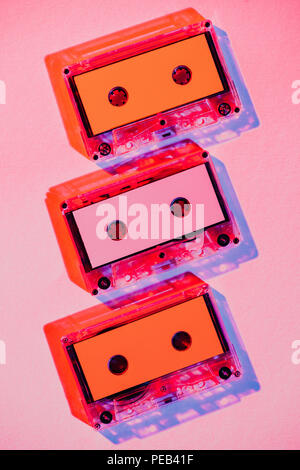 toned picture of colorful retro audio cassettes on pink background Stock Photo