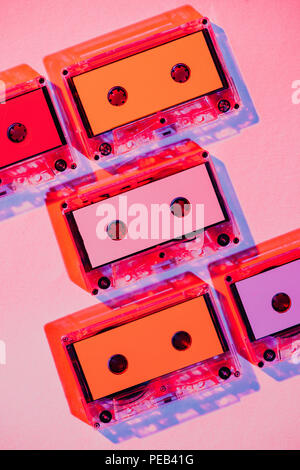 toned picture of colorful retro audio cassettes on pink background Stock Photo