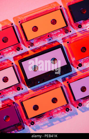 toned picture of colorful retro audio cassettes on pink background Stock Photo