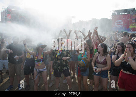 Budapest. 13th Aug, 2018. Revellers cool down in a spray of water as they party in the record heat in front of the Main Stage at the Sziget Festival held in Budapest, Hungary on Aug. 13, 2018. Credit: Attila Volgyi/Xinhua/Alamy Live News Stock Photo