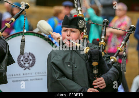 Glasgow, UK. 14th Aug 2018. Rain didn't stop play for the Brisbane Boys College Pipe Band from Australia who entertained the public by playing in rain showers in Buchanan Street, Glasgow. The World Pipe Band Championships are on Saturday 18 August with Pipe bands from around the world competing for the title. Laim Docherty from Brisbane is one of the pipers Credit: Findlay/Alamy Live News Stock Photo