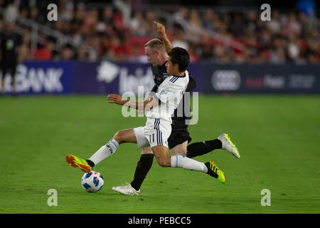 Washington, United States. 14th July, 2018. D.C. United forward Wayne Rooney (9) battles Vancouver Whitecaps forward Nicolas Mezquida (11) for a loose ball during the game between D.C. United and Vancouver Whitecaps at Audi Filed in Washington, DC on July 14, 2018. D.C. This is D.C. United's first game at Audi Field. Credit: The Photo Access/Alamy Live News Stock Photo