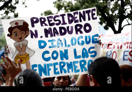 Valencia, Carabobo, Venezuela. 14th Aug, 2018. August 14, 2018. Nurses announced to go to protest in the Miraflores palace, where Venezuelan president, Nicolas Maduro, dispatches. They have already passed 51 days of protest and do not get a response from the government. At the same time they denounced once again the bad working conditions, shortage of medicines and medical supplies. The poster says: ''President Maduro speak with the nurses''. In Valencia, Carabobo state. Photo: Juan Carlos Hernandez Credit: Juan Carlos Hernandez/ZUMA Wire/Alamy Live News Stock Photo