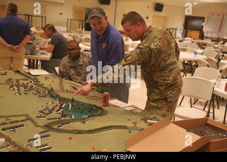 Military and civilian members of the 114th Signal Battalion meet at the Francis Scott Key Post 11 American Legion to participate in a table top exercise to re-fight the battle of Antietam, Fredericks, Md., Nov. 16, 2015. The table top exercise follows a staff ride conducted previously on the battlefield of Antietam. All members play the role of commanders during the battle to try to out maneuver the opponent armies and learn about military attack and defense strategies. (U.S. Army photo by Sgt. 1st Class Christophe D. Paul/Released) Stock Photo