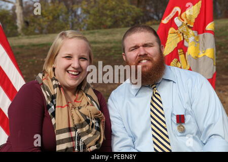 Retired US Marine Corps Cpl. Brandon Burns and his wife Laura pose for a photo after his Good Conduct Medal presentation at the Wounded Warrior Regiment Headquarters, Marine Corps Base Quantico, Va., Nov. 18, 2015. Burns was presented the award nine years after medically retiring from the Marine Corps. (US Marine Corps photo by 1st Lt. Andrew Bolla/Released) Stock Photo