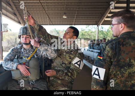 A U.S. Army jumpmaster inspects a paratrooper's equipment in preparation for sustained airborne training on ‘lottery day’ of the 18th Annual Randy Oler Memorial Operation Toy Drop, hosted by U.S. Army Civil Affairs & Psychological Operations Command (Airborne), Dec. 4, 2015, at Pope Field, N.C. Operation Toy Drop is the world’s largest combined airborne operation and allows Soldiers the opportunity to help children in need everywhere receive toys for the holidays. (U.S. Army photo by Timothy L. Hale/Released) Stock Photo