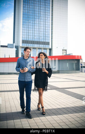 Modern business man and woman wearing smart casual clothes in the city. Urban lifestyle. Stock Photo