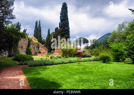 Walking Path in a Garden with Ruins, Ninfa Garden, Cisterna di Latina, Italy Stock Photo