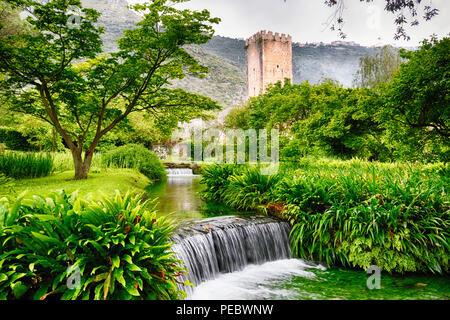 Cascading Creek in a Garden with a Medieval Tower, Latina Italy Stock Photo
