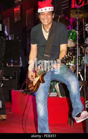 Rock guitarist in Christmas show on Walking Street, Pattaya, Thailand Stock Photo