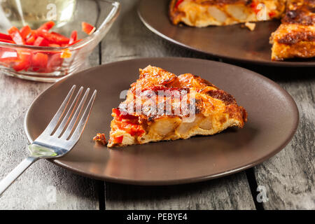 Tortilla de patatas. Spanish omelette with sausage chorizo, potatoes, paprika and egg, accompanied by olive oil. Spanish cuisine Stock Photo