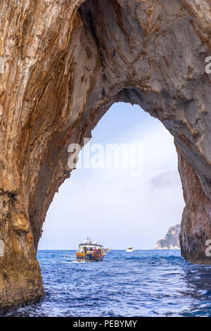Approaching the Faraglioni by boat these are stacks formed from rocks on the southern side of Capri, one distinguishing feature is the archway Stock Photo