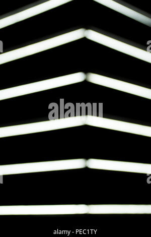 close up view of blurred white lightning lamps on black background Stock Photo