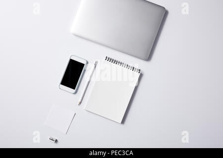 top view of arranged various business workplace objects on white surface for mockup Stock Photo