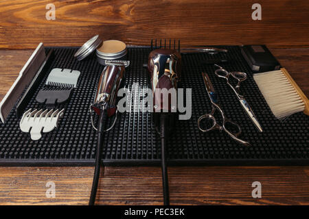 electric clippers, professional scissors and hair wax in barbershop Stock Photo