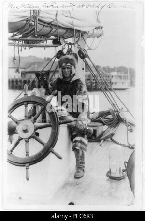 Arctic explorer Donald MacMillan in fur suit at wheel of ship Bowdoin Stock Photo