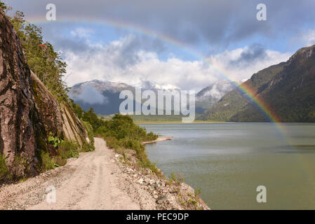Gravel road with rainbow at Puerto Río Tranquilo, Carretera Austral, Valle Exploradores, Patagonia, Chile Stock Photo