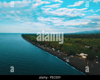 Aerial drone view of the beautiful green coastline in Bali, Indonesia. Stock Photo