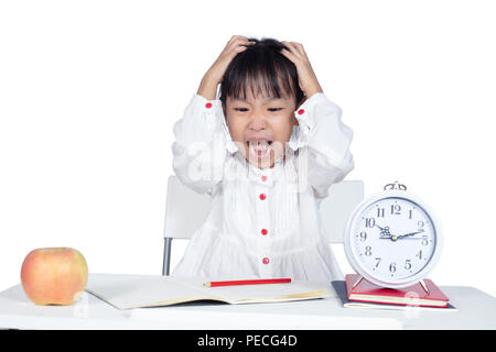 Asian Chinese Little Girl doing homework in isolated white background Stock Photo