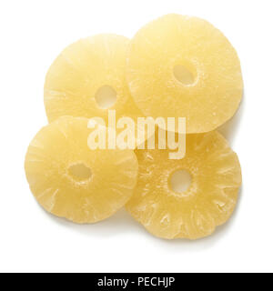 Sweet dried pineapple rings isolated on white background. Top view of candied sliced fruits. Stock Photo