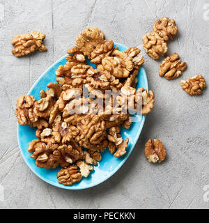 Walnut kernels on gray background. Stock Photo